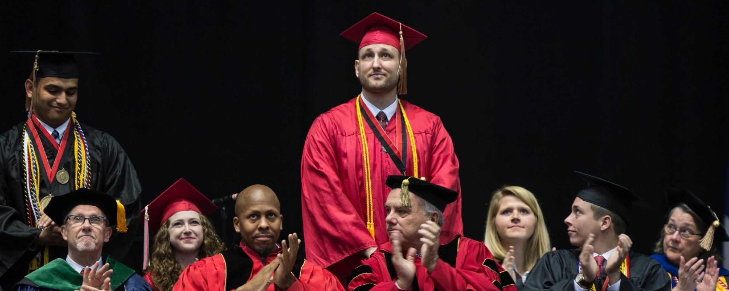 Cory Murphy stands to be recognized during commencement