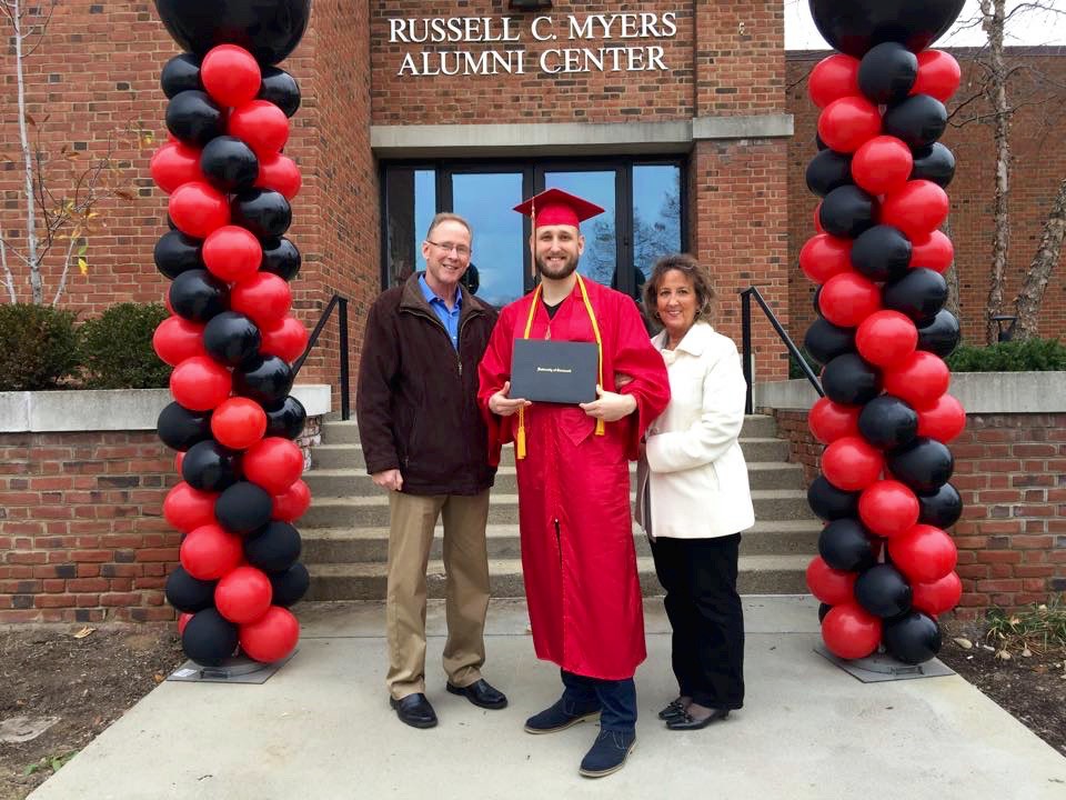 Murphy stands with his parents after commencement on UC's campus.
