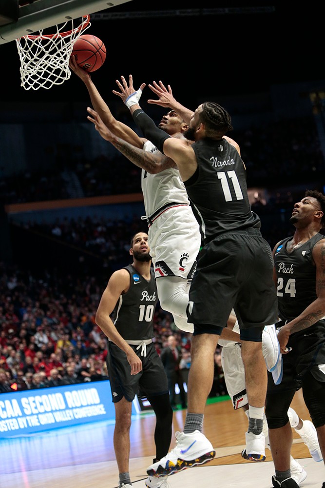 Jacob Evans III drives the lane for a contested lay-up. 