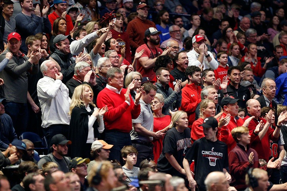 A crowd of UC fans cheering. 