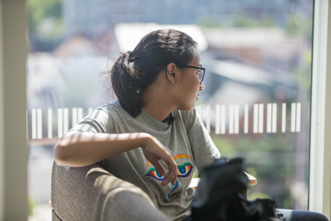 Pranita Dhungana looks at the window of her new home at Scioto Hall. Photo/Andrew Higley/UC Creative Services