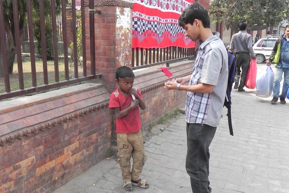 While he doesn’t have much, Sudarshan Pandey gives what he has in his pockets to a little boy on the streets of Nepal. Photo/Provided