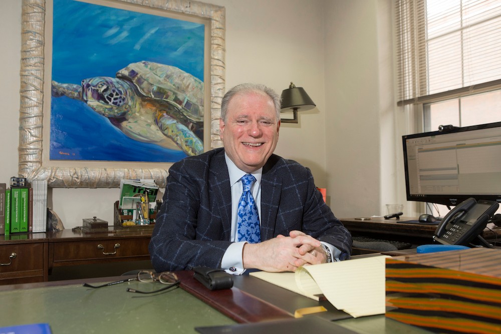 David Altman sits at his desk at his firm.