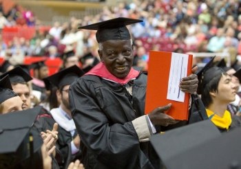 Samuel Obura stands during the ceremony when recognized by UC President Santa Ono.