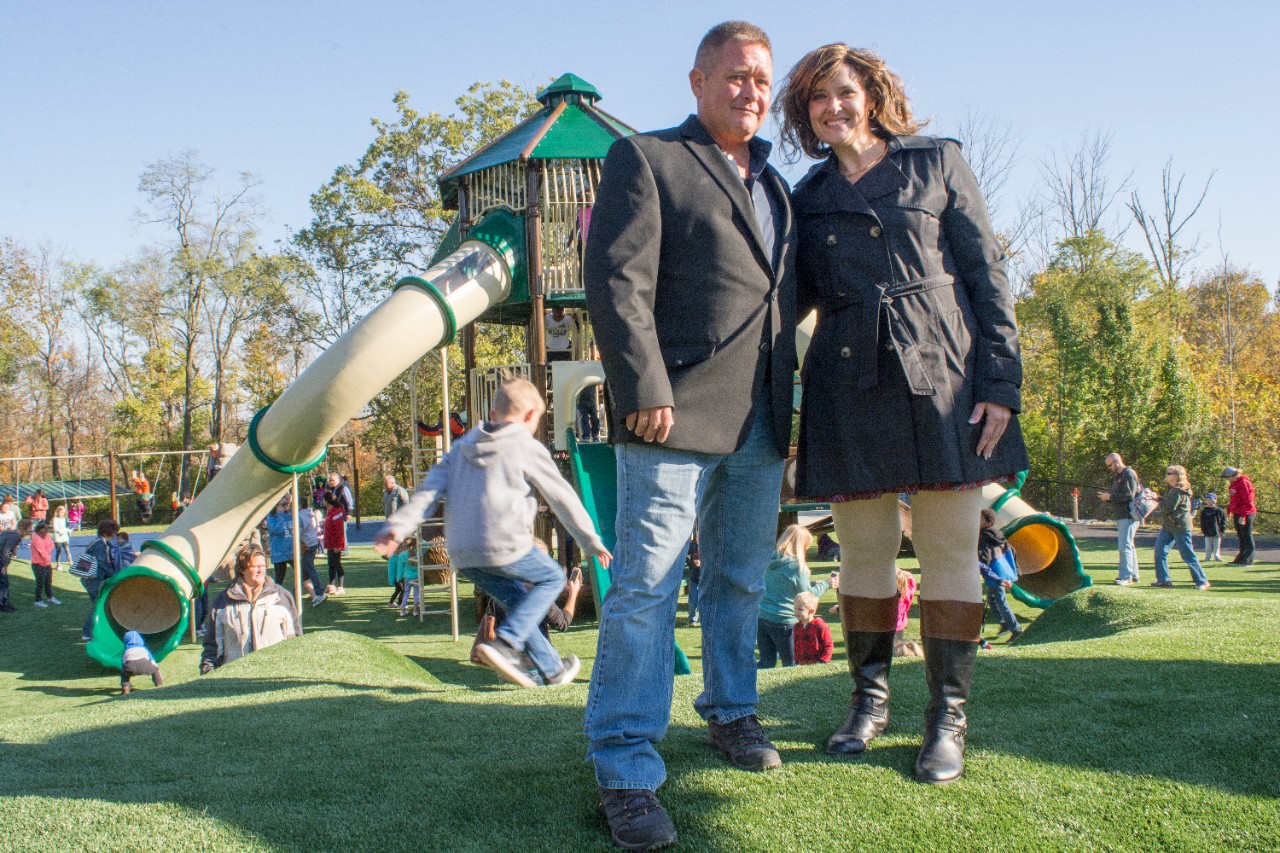 Eric Schmidt and Tina Stanton-Chapman stand atop a hill in the new playground. 