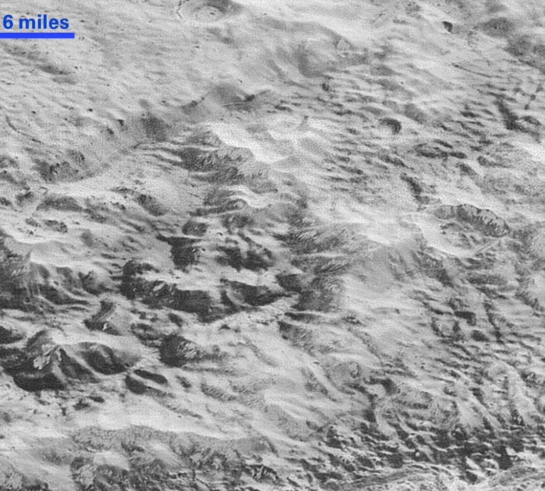 New Horizons captured this image of what scientists call Pluto’s “badlands,” an area of rugged hills fronting a 1-mile-tall cliff. (NASA/Johns Hopkins University Applied Physics Laboratory/Southwest Research Institute)