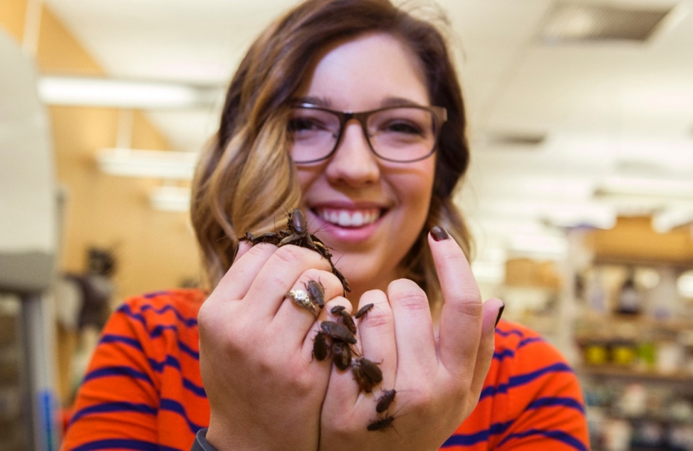 Image of Emily Jennings with the mimic beetle cockroach