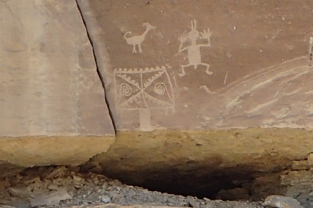 Scratched carvings of a goat, man and a ceremonial design on the ancient walls of a Great House in Chaco Canyon, New Mexico