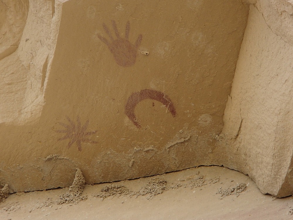 Painting of a crescent moon and a hand on the wall inside an ancient Great House in Chaco Canyon, New Mexico