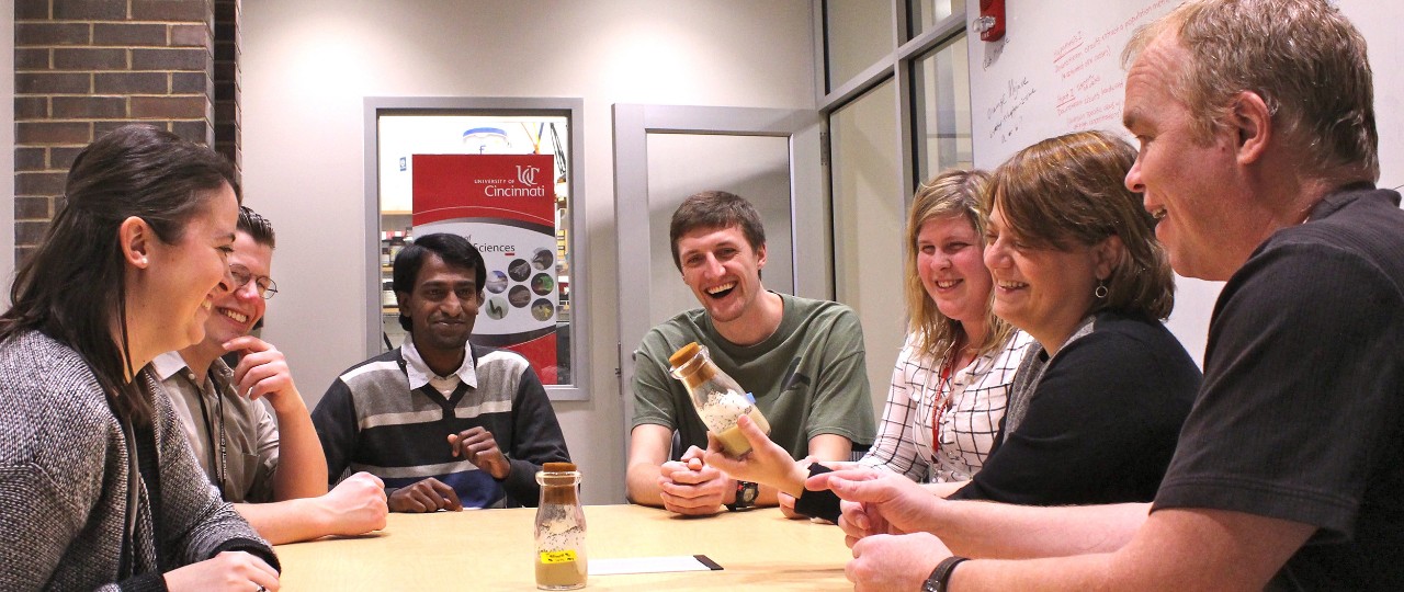 Fruit fly researchers from UC sitting around a table