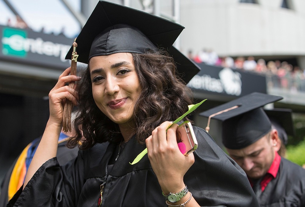  A graduate turns the tassel on her cap