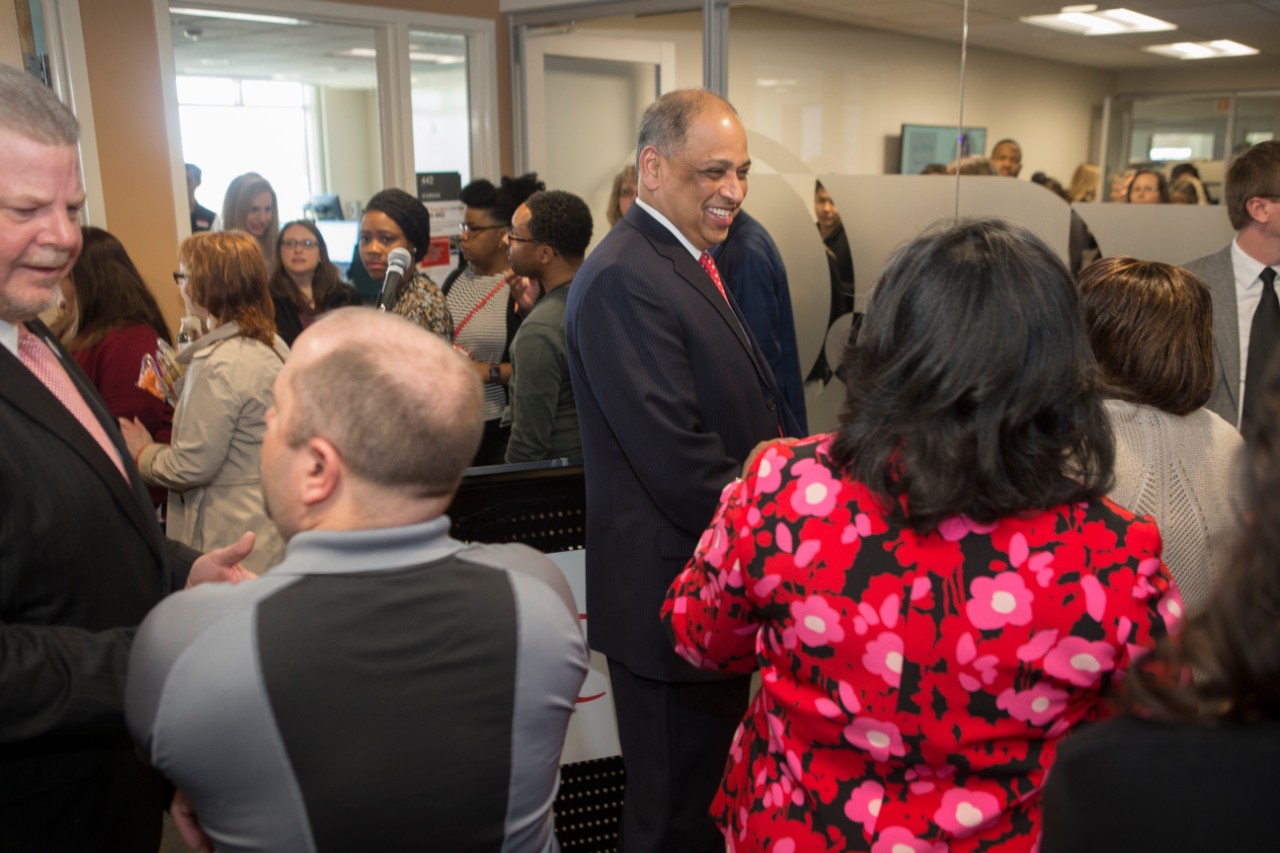 UC President Neville Pinto speaks with UC staff at the Staff Success Center ribbon cutting event.