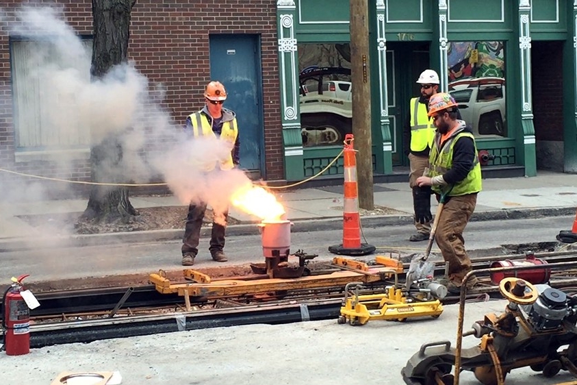 Crews use a process known as thermite welding to connect two steel rails together. Shown is the final weld in the Over-The-Rhine segment, December 15, 2014.