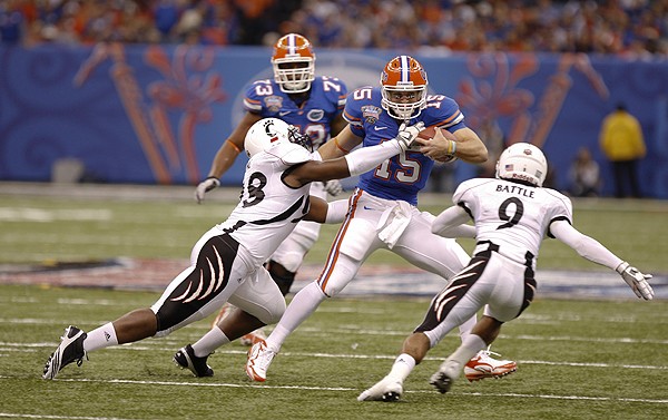 UC attempts to corral Florida quarterback Tim Tebow, who set BCS records with 533 yards of total offense.