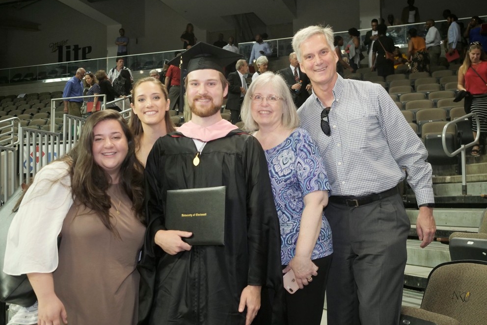 A graduate poses with his proud family. 