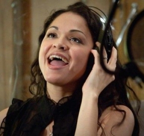 Karen wearing headphones while singing in a recording sessiong.