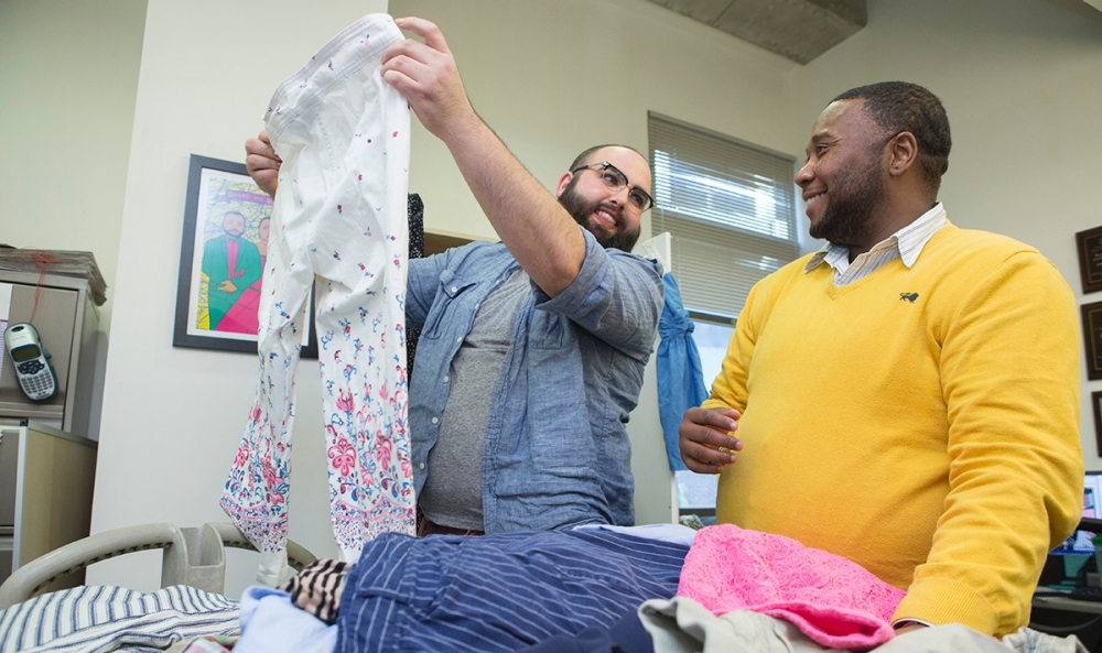 Lee Dyer, right, a program coordinator in the University of Cincinnati LGBTQ Center, helps graduate assistant Sol sort through clothing donations made to the center's 'The Closet' clothing bank for transgender and gender nonconforming students. 