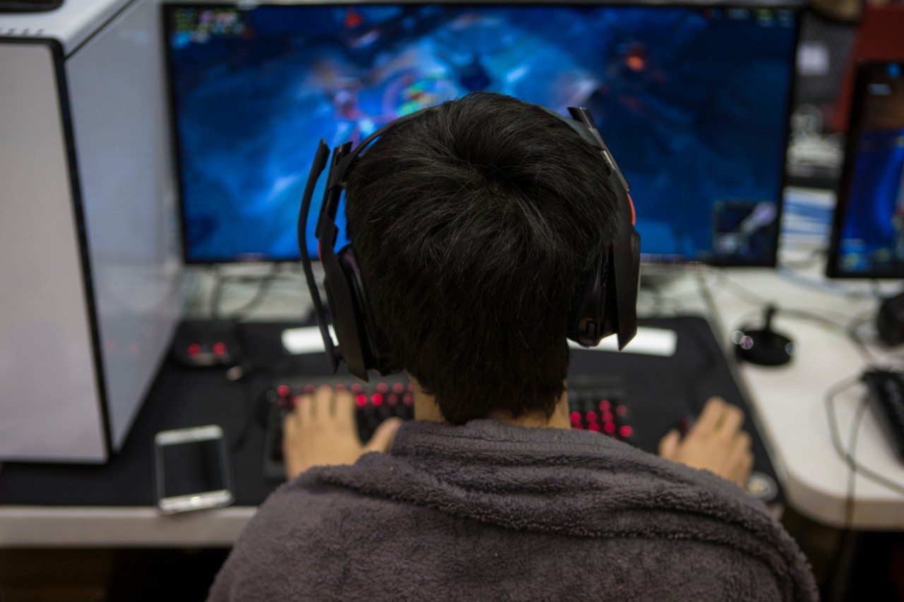 Back of a student's head with computer monitor in distance