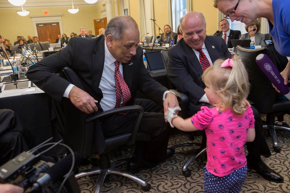 Ella Morton shakes hands with UC President Neville Pinto and meets UC Board of Trustees Chair Thomas Cassady (right). At far right is Ella's Mom, Heather Morton. The three-year-old received a new 3-D printed prosthetic hand created by the UC student group EnableUC.   Photo/Joseph Fuqua II