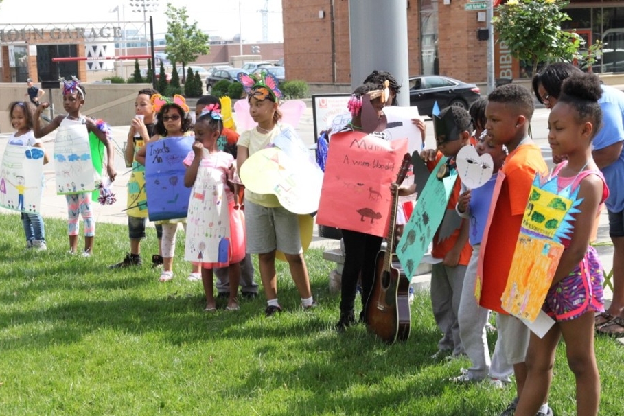 Children from Corryville Catholic School stand in a vocabulary parade during UC Serves Day.