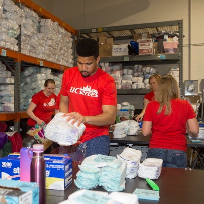 UC Serves volunteers wrap packages of diapers for Sweet Cheeks Diaper Bank on UC Serves Day. photo/Joseph Fuqua II/UC Creative Sevices