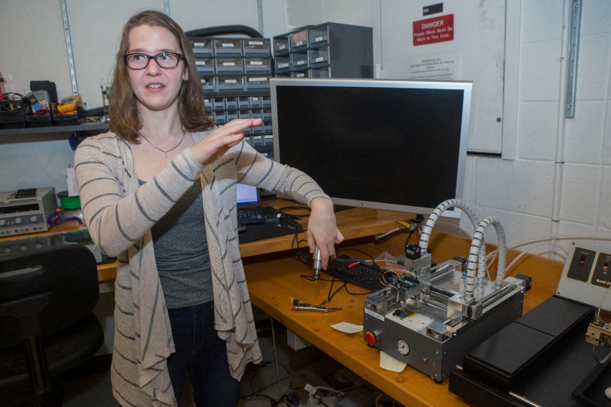 UC engineering student Laura Stegner works on a milling machine to customize flow-rate sensors in the Novel Devices Lab. 