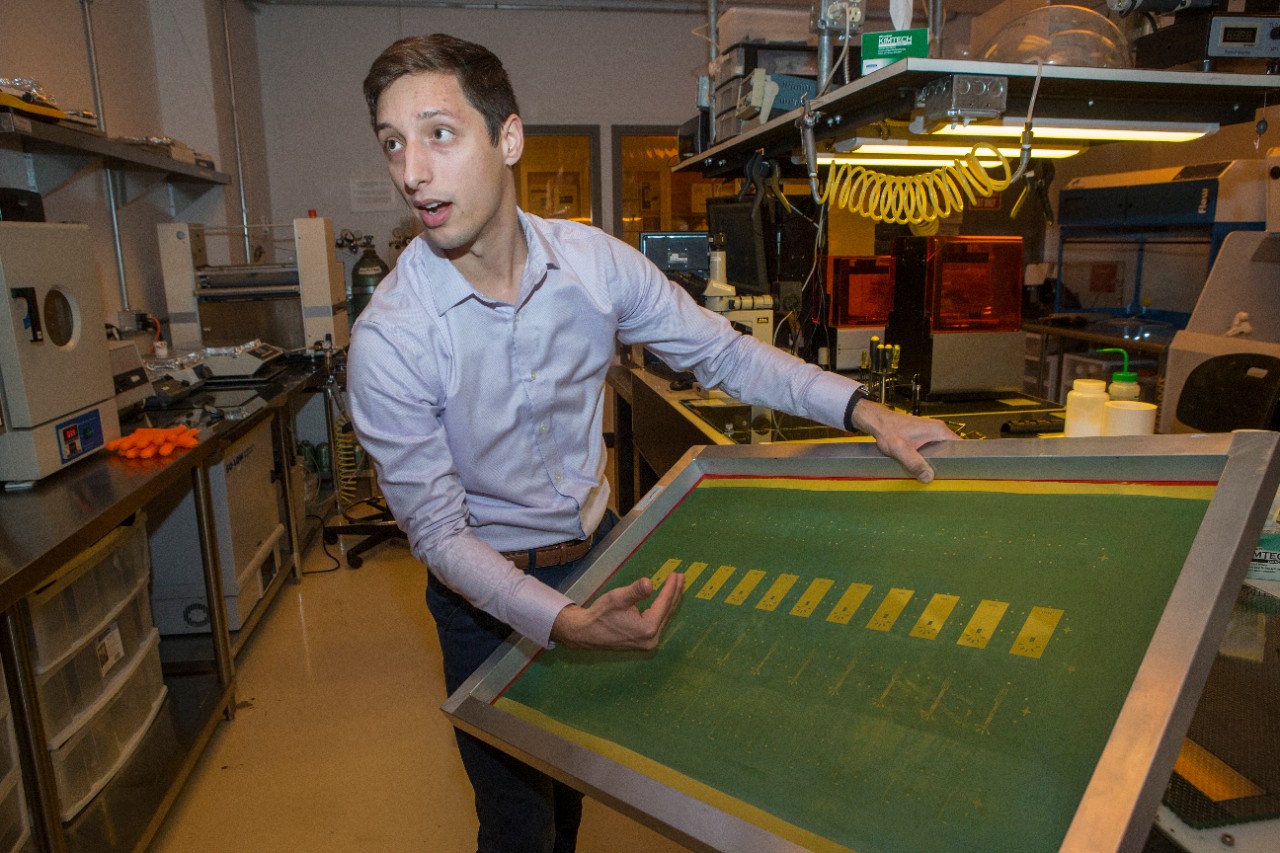UC engineering student Andrew Jajack holds up a mold used to produce sensors.