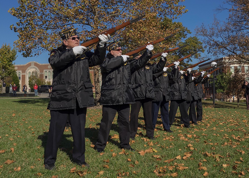 Members of the Honor Guard American Legion Post 530 issue rifle fire.