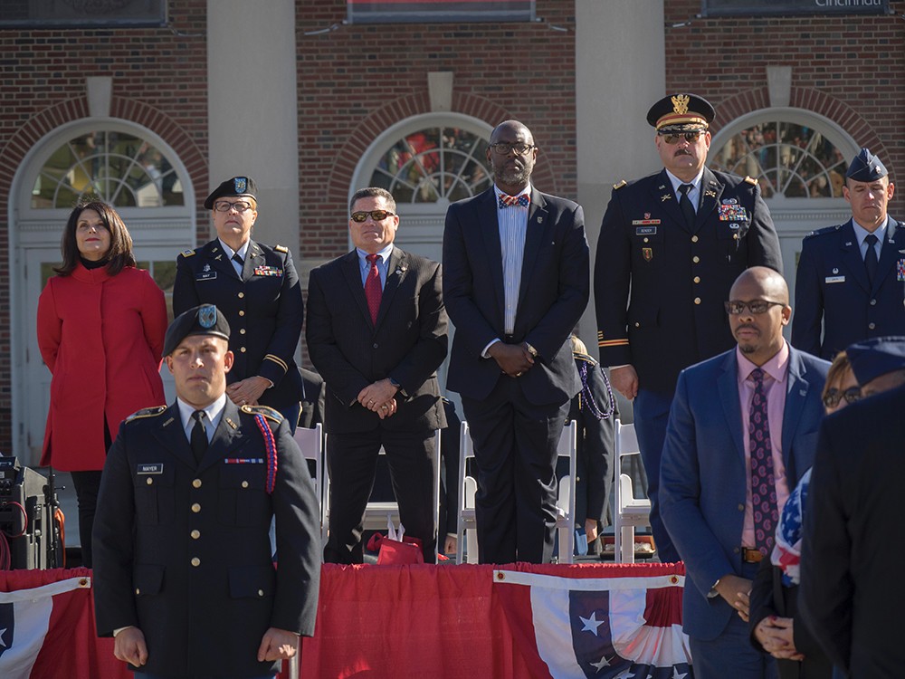 UC faculty and staff are joined on stage by area veterans and distinguished guests.