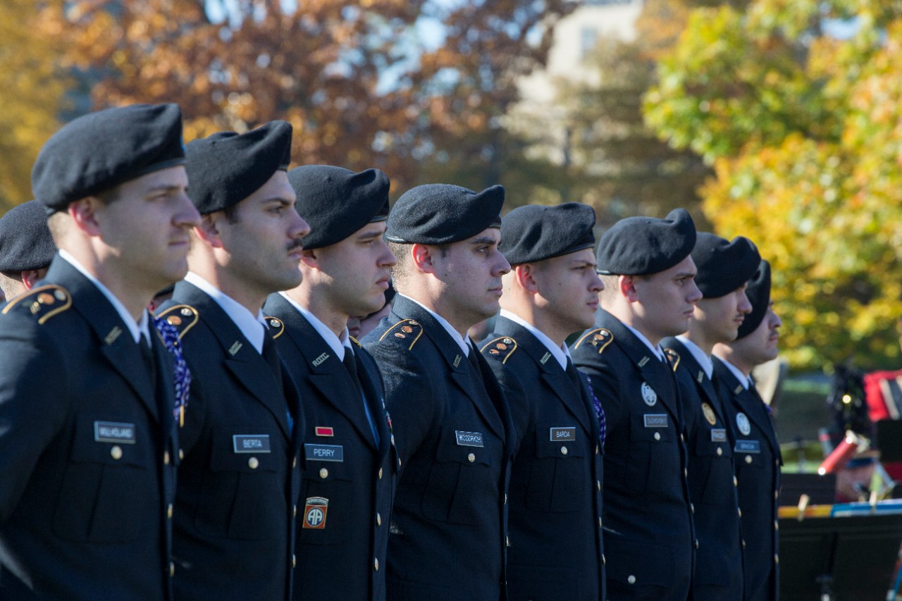 Army ROTC cadets stand at attention. 