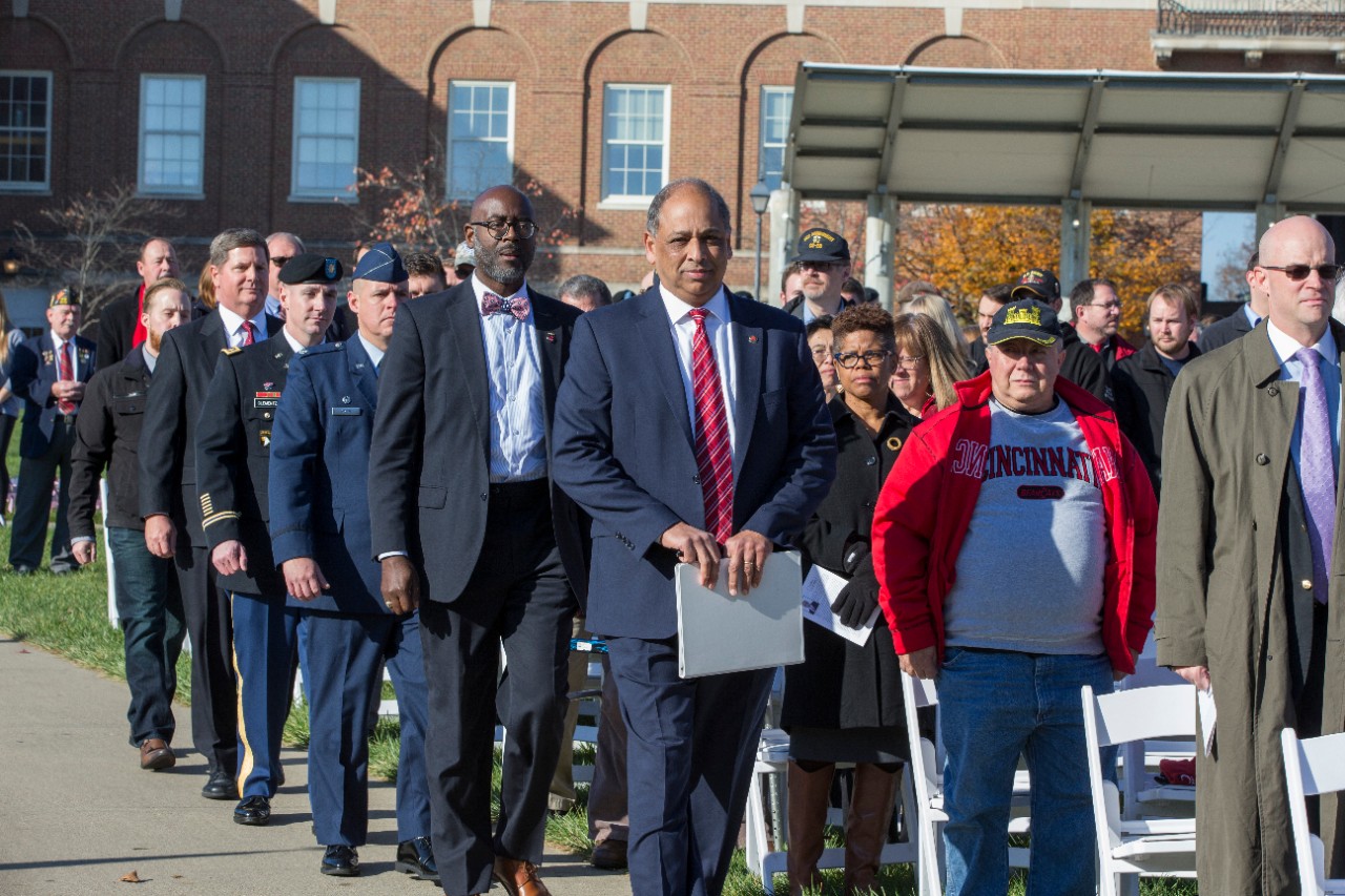 UC President Neville Pinto, Veterans Programs & Services Director Terence Harrison and the ceremony's guest speakers make their way to the stage. 