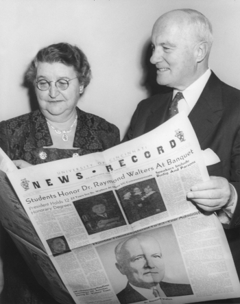 President and Mrs. Raymond Walters hold a special souvenir edition of The News Record, presented to the couple at the president's student-sponsored retirement dinner in 1955.