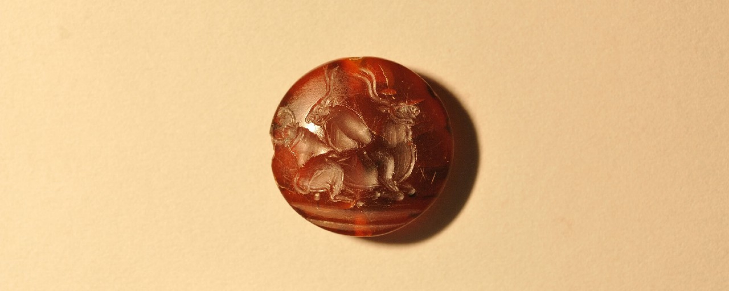 This is one of more than four dozen seal stones with intricate Minoan designs found in the tomb. Long-horned bulls and, sometimes, human bull jumpers soaring over their horns are a common motif in Minoan designs.