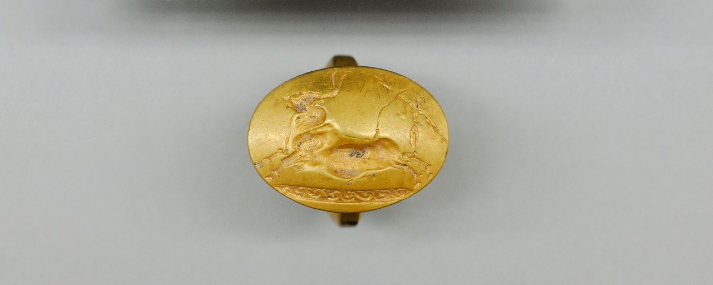 This gold ring with a Cretan bull-jumping scene was one of four solid-gold rings found in the tomb. This number is more than found with any other single burial elsewhere in Greece.