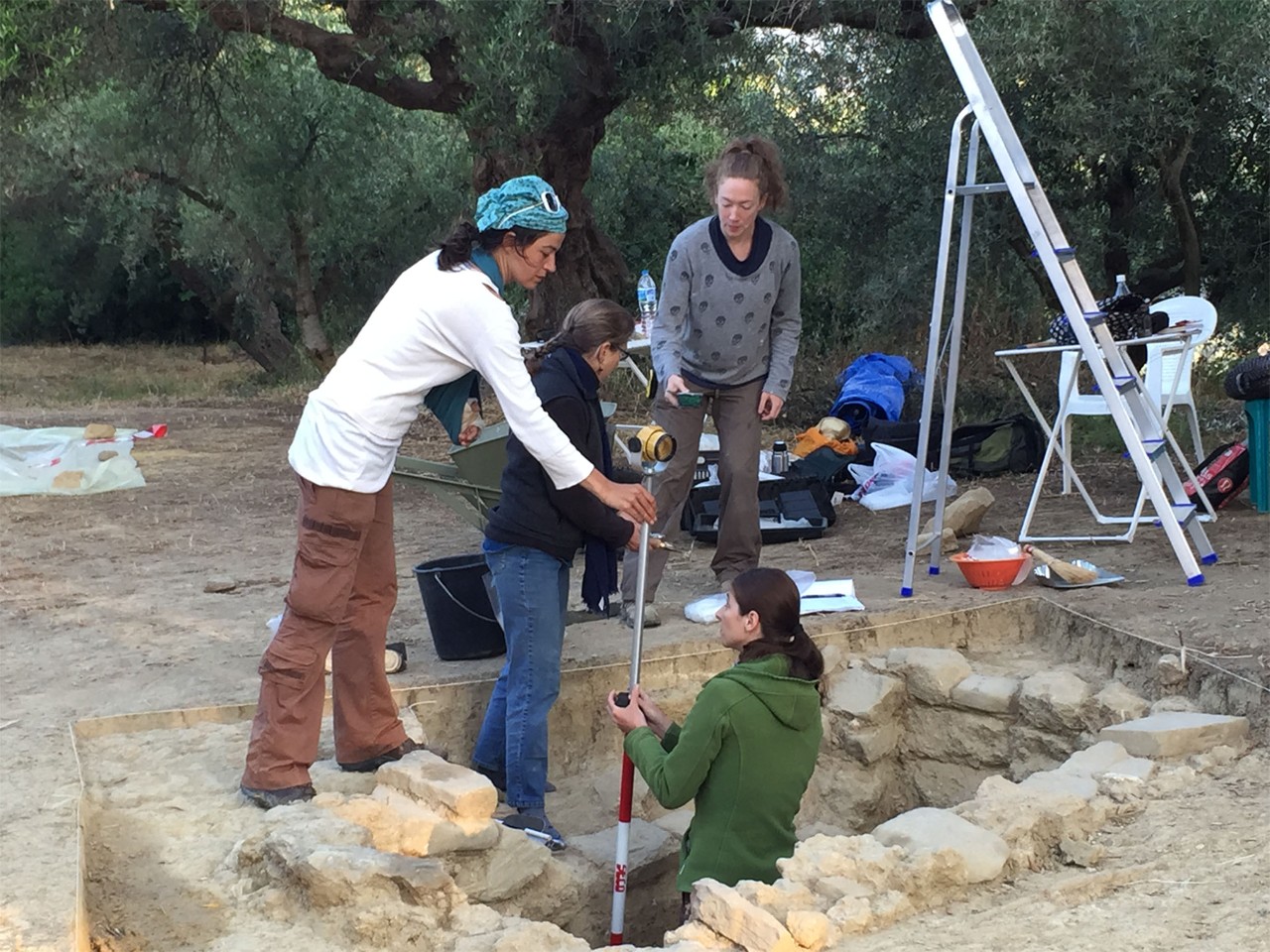 From left are Denitsa Nenova, University College London; UC's Sharon Stocker; Alison Fields, UC graduate student in classics; and in the trench is Jonida Martini, a UC graduate who earned her M.A. in classics. x