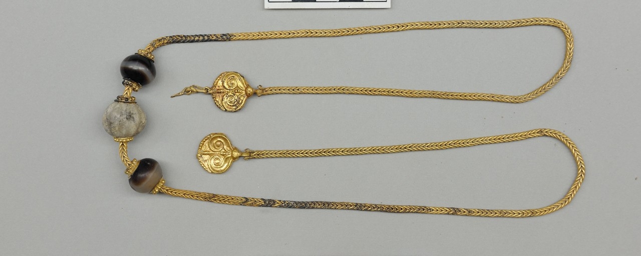 This unique necklace measures more than 30-inches long and features two gold pendants decorated with ivy leaves. It was found near the neck of the warrior's skeleton. Gold necklace