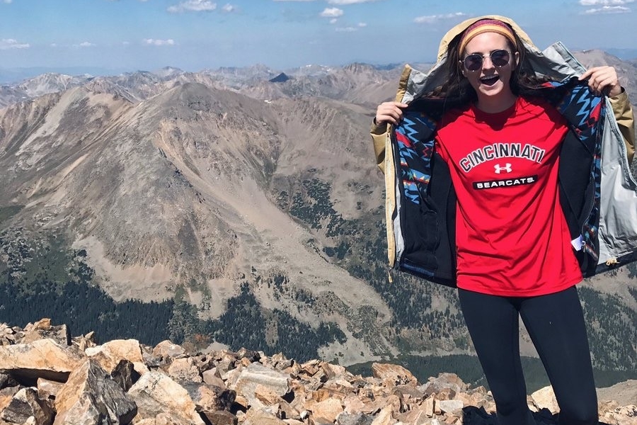UC student Erin Walsh showing her UC T-shirt while on the peak of Colorado's Mt. Elbert in 2017. photo/Erin Walsh