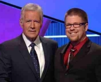 UC grad John Anneken poses with Jeopardy host Alex Trebek