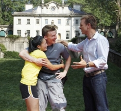 Phil Keoghan greets Cindy Chiang and Ernie Halvorsen