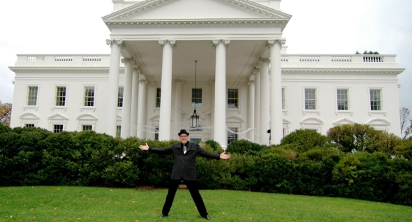 Phil Solomon stands in front of the White House in his regular clothes before the festivities begin.