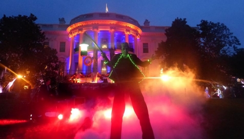 Herman Munster, on stits, poses in the dark in front of the White House as artificial fog starts to fill the grounds.