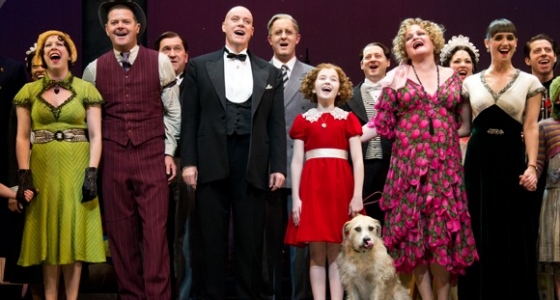 The entire case of "Annie" is lined up for a curtain call, including the dog "Sandy."