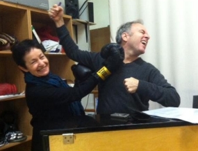 Lynn Ahrens and Stephen Flaherty joking exchange punches while working on the Rocky score.