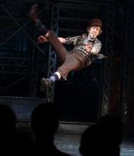 Ryan Breslin leaps at the opening-night curtain call of "Newsies."