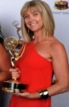 Cara holding the Emmy she won in 2013