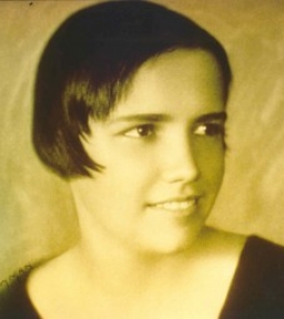 Head shot of Louise McCarren in a pixie haircut.