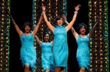 Four African-American women dancers in turquoise dresses.