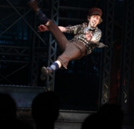 Ryan Breslin leaps at the opening-night curtain call of "Newsies."
