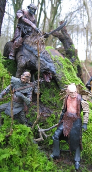 The Yazneg figure and other Hobbit figures set up in real grass and trees.