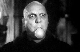  Jackie Coogan, playing Uncle Fester in the original Addams Family, lights his light bulb in his mouth.